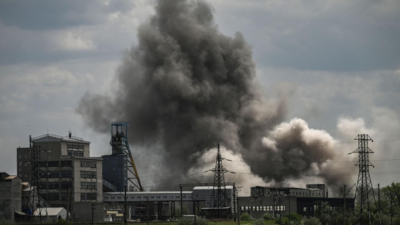 Smoke and dirt ascends after a strike at a factory in the city of Soledar at the eastern Ukranian region of Donbas on May 24, 2022, on the 90th day of the Russian invasion of Ukraine. (Photo by ARIS MESSINIS / AFP)