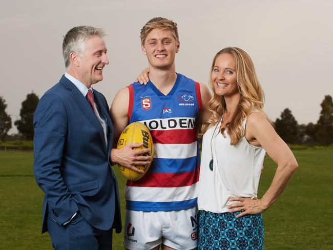 Jackson Hately, in his Central District playing kit before being drafted by GWS last year, with his parents Nick and Melinda. Picture: MATT LOXTON