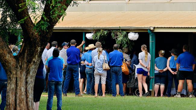 Arm in arm, Kate Everett, Meg Everett, and Tick Everett arrive surrounded by family and friends at Casuarina Street primary school for Dolly Everett's memorial service in Katherine, Northern Territory.