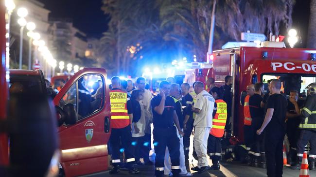 Police officers, firefighters and rescue workers are seen at the site of the attack. Picture: AFP