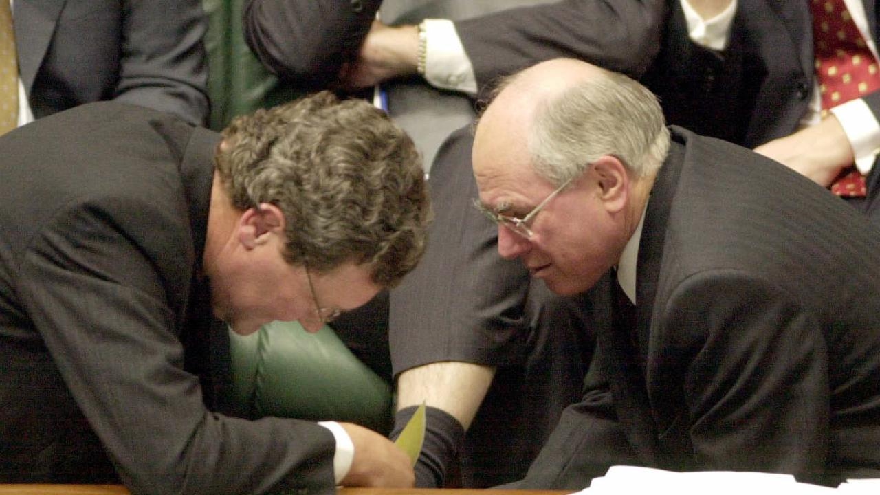 Foreign Affairs Minister Alexander Downer (left) with Prime Minister John Howard during Question Time in federal parliament on August 21, 2002.