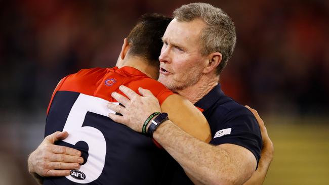 Christian Petracca embraces Brendan McCartney after a Melbourne game. Picture: Adam Trafford/AFL Media/Getty Images.