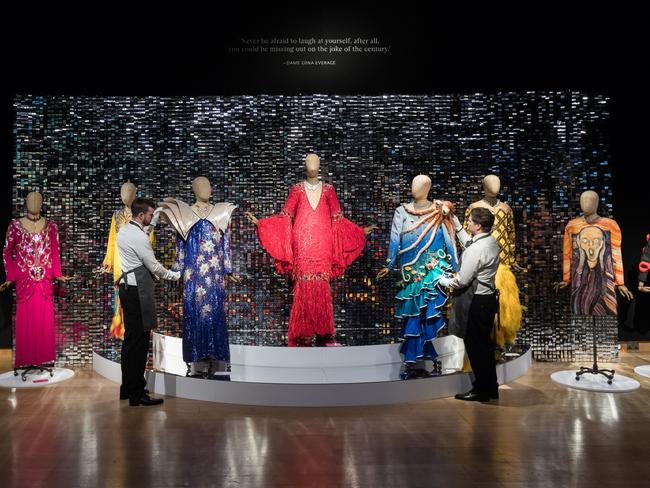 Art handlers pose with the extravagant costumes from flamboyant wardrobe of Dame Edna Everage at Christie's auction house. Picture: Wiktor Szymanowicz/Future Publishing via Getty Images