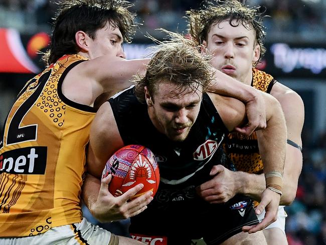 ADELAIDE, AUSTRALIA - MAY 19:   Jason Horne-Francis of the Power  tackled by  Will Day of the Hawks during the round 10 AFL match between Yartapuulti (the Port Adelaide Power) and Hawthorn Hawks at Adelaide Oval, on May 19, 2024, in Adelaide, Australia. (Photo by Mark Brake/Getty Images)