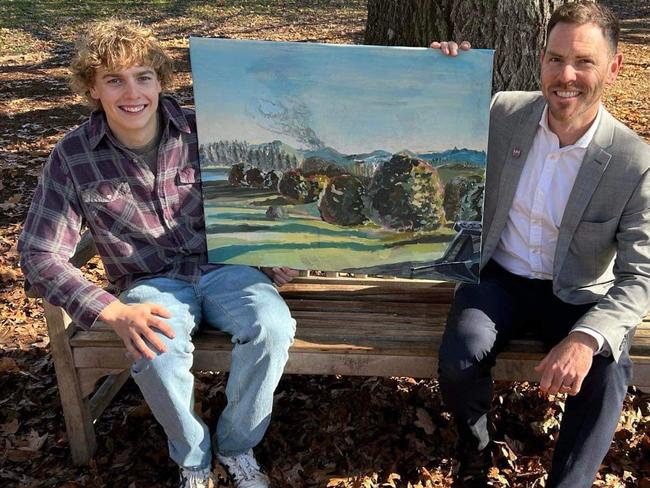 Oxley College teacher Justin Verco (right) with the original painting gifted to him by student Joe Quilty