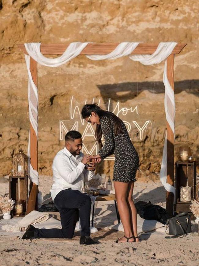 Malith Bamunuarachchi proposes to Mel Joseph at Port Willunga Beach. Picture: SvenStudio