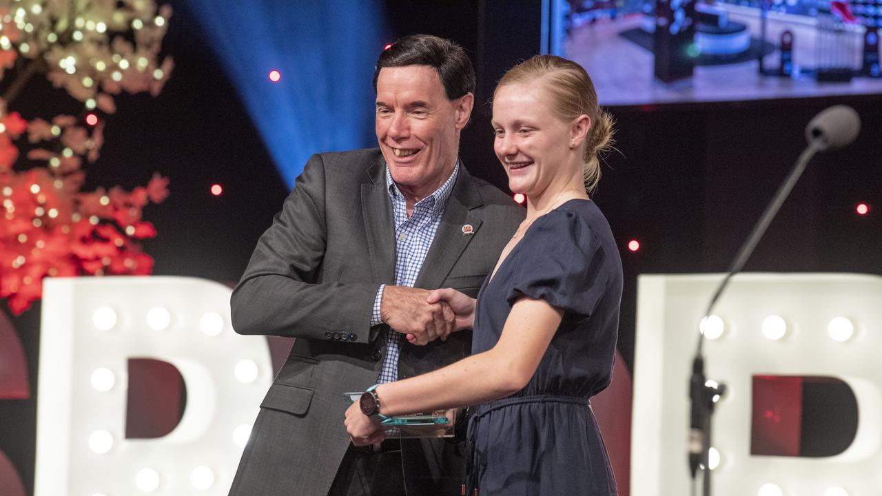 Lucy Dyson receives the Junior Chase Your Dreams award from Doug Muir, Athletes Foot. Sports Darling Downs Sports Stars of the Year dinner. Saturday, February 11, 2023. Picture: Nev Madsen.