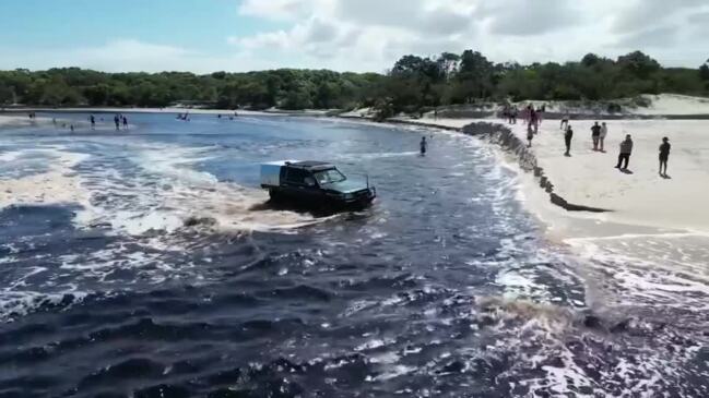 Drone vision of lagoon flowing into ocean at Bribie Island after breaking banks