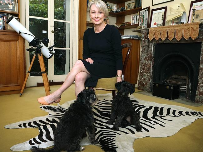 Anne Moran and her poodles on a fake zebra skin rug. Picture Dean Martin