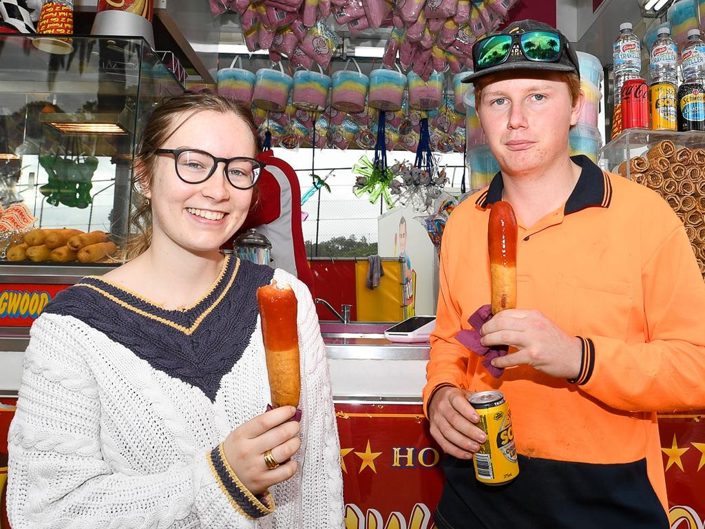 Hitting up the dagwood dogs early are Goonellabah duo Tara Blunn and Sean Boulton, at the Lismore Show. Picture: Cath Piltz