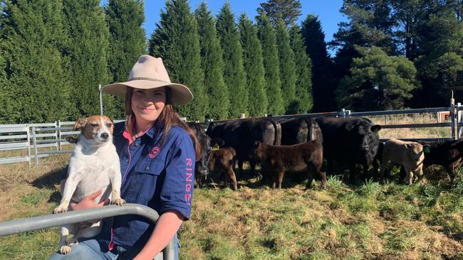 Samantha Larter, 23, with her dog at the family farm in Moss Vale.