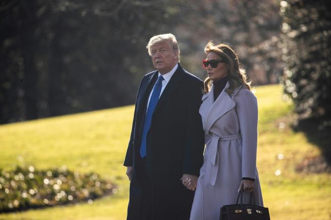 Donald Trump and Melania Trump walk across the South Lawn at the White House in January 2020 in Washington, DC