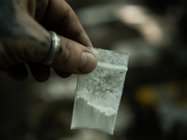 Generic crime Istock  -  Man holding in hands small bag with cocaine