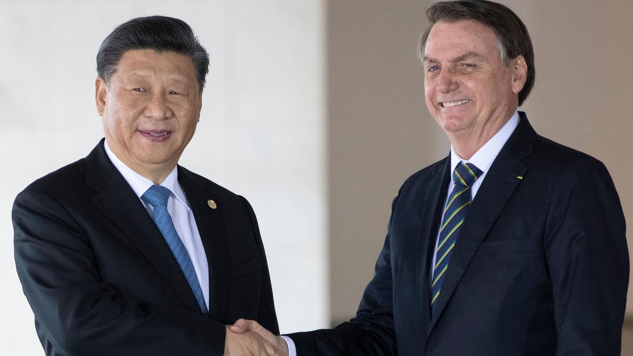 Brazil's President Jair Bolsonaro (R) and China's President Xi Jinping shake hands before the 11th BRICS Summit at the Itamaraty palace on November 14, 2019 in Brasilia, Brazil. Picture: Pavel Golovkin