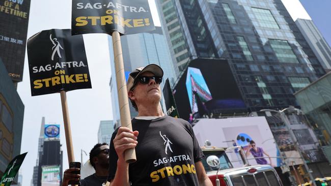 NEW YORK, NEW YORK - JULY 17:  Kevin Bacon and SAG-AFTRA members and supporters protest as the SAG-AFTRA Actors Union Strike continues in front of Paramount Studios at 1515 Broadway on July 17, 2023 in New York City. Members of SAG-AFTRA, HollywoodÃ¢â¬â¢s largest union which represents actors and other media professionals, have joined striking WGA (Writers Guild of America) workers in the first joint walkout against the studios since 1960. The strike could shut down Hollywood productions completely with writers in the third month of their strike against the Hollywood studios. (Photo by Michael Loccisano/Getty Images)