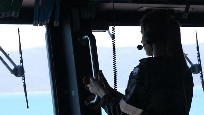 A Royal Australian Navy sailor from HMAS Brisbane on the bridge during search and rescue operations in the vicinity of Lindeman Island, Queensland, 29 July 2023. A multi-national and multi-agency search and rescue effort is underway following an Australian Army MRH-90 Taipan helicopter impacting waters near Lindeman Island on the night of 28 July 2023 during Exercise Talisman Sabre 23. *** Local Caption *** Exercise Talisman Sabre 2023 is being conducted across northern Australia from 22 July to 4 August.  More than 30,000 military personnel from 13 nations will directly participate in Talisman Sabre 2023, primarily in Queensland but also in Western Australia, the Northern Territory and New South Wales.   Talisman Sabre is the largest Australia-US bilaterally planned, multilaterally conducted exercise and a key opportunity to work with likeminded partners from across the region and around the world.  Fiji, France, Indonesia, Japan, Republic of Korea, New Zealand, Papua New Guinea, Tonga, the United Kingdom, Canada and Germany are all participating in Talisman Sabre 2023 with the Philippines, Singapore and Thailand attending as observers.  Occurring every two years, Talisman Sabre reflects the closeness of our alliance and strength of our enduring military relationship with the United States and also our commitment to working with likeminded partners in the region.  Now in its tenth iteration, Talisman Sabre provides an opportunity to exercise our combined capabilities to conduct high-end, multi-domain warfare, to build and affirm our military-to-military ties and interoperability, and strengthen our strategic partnerships.