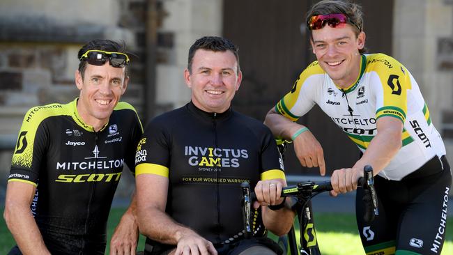 Mitchelton-Scott riders Mathew Hayman, left, and Alex Edmondson, right, with Garry Robinson, a cyclist from the Invictus Games. Picture: Naomi Jellicoe