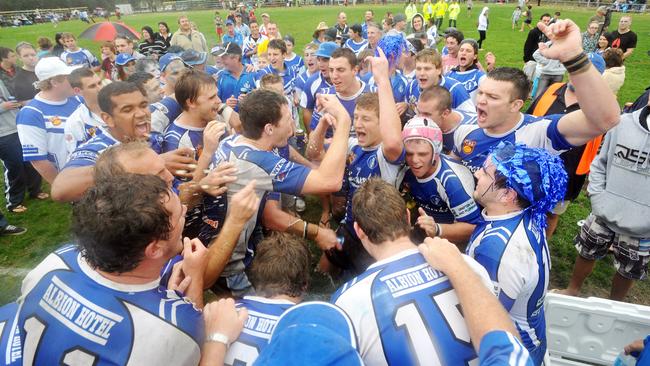 Grafton Ghosts players celebrate with the team song after winning the NRRRL grand final.