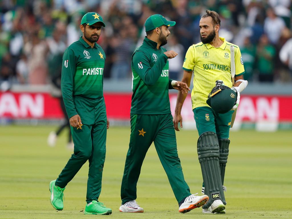 Pakistan's Shadab Khan (C) and teammate Babar Azam (L) walk with South Africa's Imran Tahir (R) after victory in the 2019 Cricket World Cup group stage match between Pakistan and South Africa at Lord's Cricket Ground. Picture: Adrian Dennis/AFP