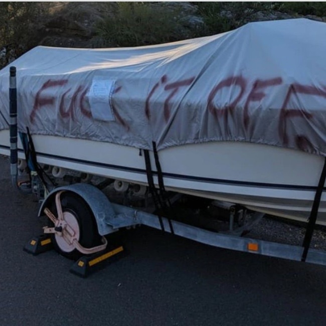 Boat and trailer parking can prompt neighbourhood disputes. A painted message daubed on a boat parked at Freshwater. Picture: Reddit