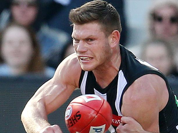 AFL Round 22. 18/08/2018. Collingwood vs Port Adelaide at the MCG .   Collingwood's Taylor Adams clears by hand   . Pic: Michael Klein