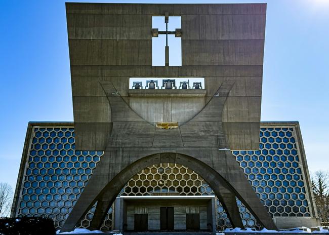 The tale of the Saint John's Abbey Church is as unlikely as the movie plot it inspired, spanning titans of architecture, ambitious monks, Vatican reform -- and an almighty row over its beehive window