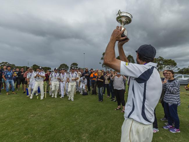 Pearcedale captain Kaine Smith shows his players the premiership cup. Picture: Valeriu Campan