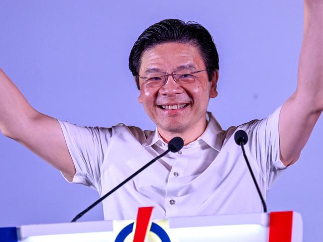 Singapore's Prime Minister and secretary-general of the ruling People's Action Party (PAP) Lawrence Wong gestures to supporters during an election rally in Singapore on May 1, 2025. (Photo by Roslan RAHMAN / AFP)
