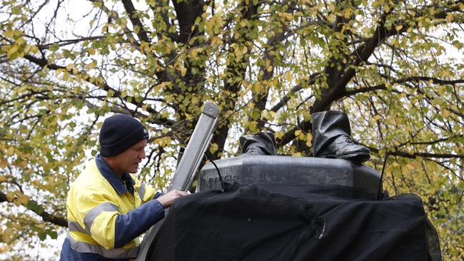 Council workers covering the remainder of the statue. The William Crowther statue in Franklin Square Hobart has been vandalised overnight resulting in the statue being removed from it's plinth and then removed by Hobart City Council. Picture: Nikki Davis-Jones