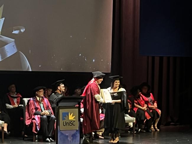 Graduates from the University of the Sunshine Coast's Fraser Coast campus celebrating at the Brolga Theatre.