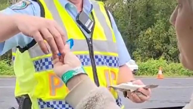 NO GLOVES: An image supplied by Greens MP Cate Faehrmann, which she said was taken by a staff member, allegedly shows the police officer conducting the RDT not wearing latex gloves, as she headed into Mardigrass on May 2, 2021. Image supplied