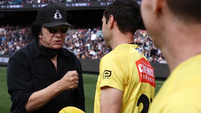 Kiss frontman Gene Simmons presents the ball to the umpires before the Carlton against Collingwood game at the MCG. Picture: Michael Klein