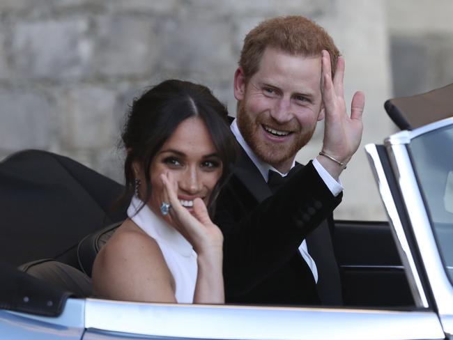 The newly married Duke and Duchess of Sussex, Meghan Markle and Prince Harry, leave Windsor Castle in a jaguar for their evening reception. Picture: Steve Parsons/PA via AP.