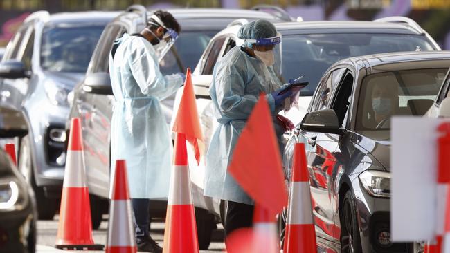 People line up at a drive-through testing centre in St Kilda. Picture: Daniel Pockett