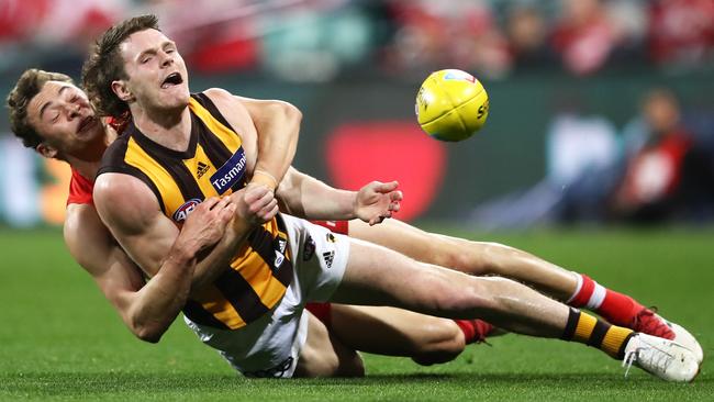 Blake Hardwick of the Hawks is run down by Will Hayward of the Swans during the Round 23 match at the SCG. Picture: AAP