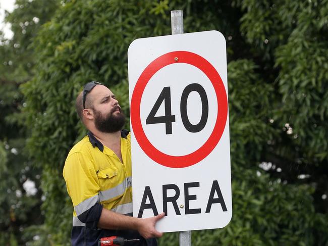 Cairns Regional Works department staff Joel Clement puts up the 40km speed limit signs on Aplin StPICTURE: ANNA ROGERS