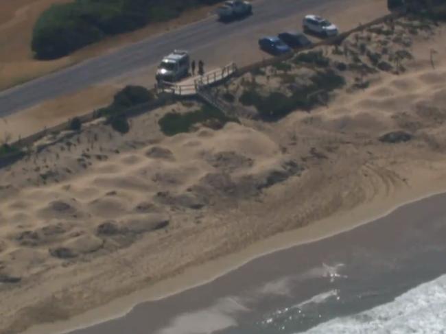 A woman walking along the beach jumped in to rescue the unconscious men. Picture: 9 News