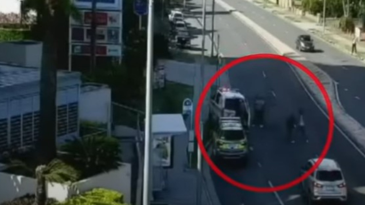The group of men fight the emergency workers in the middle of the Gold Coast highway. Picture: 9News