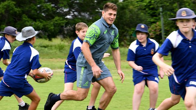 James O’Connor gets involved in a skills clinic with year 6 students at Cannon Hill Anglican College on Monday. Picture: AAP