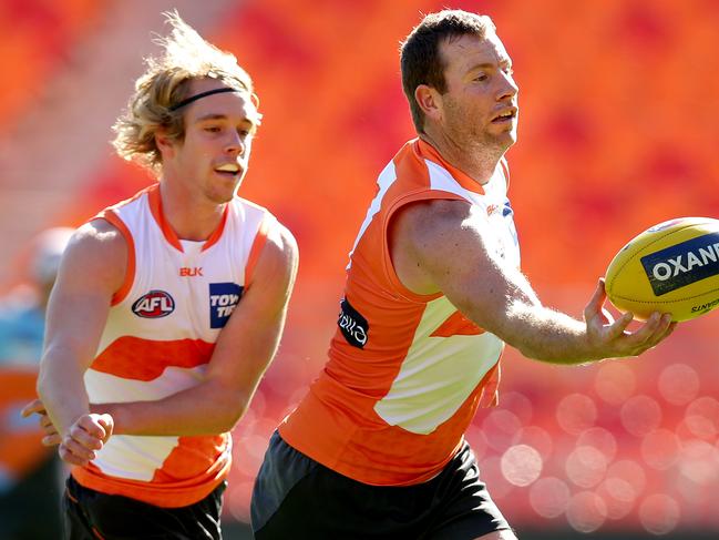 Pat McKenna trails GWS teammate Steve Johnson at training. Picture: Gregg Porteous.