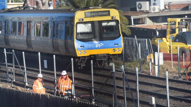 Sky rail noise; workers working on the Pakenham/Cranbourne line just outside of Murrumbeena Train Station. Picture: Tony Gough