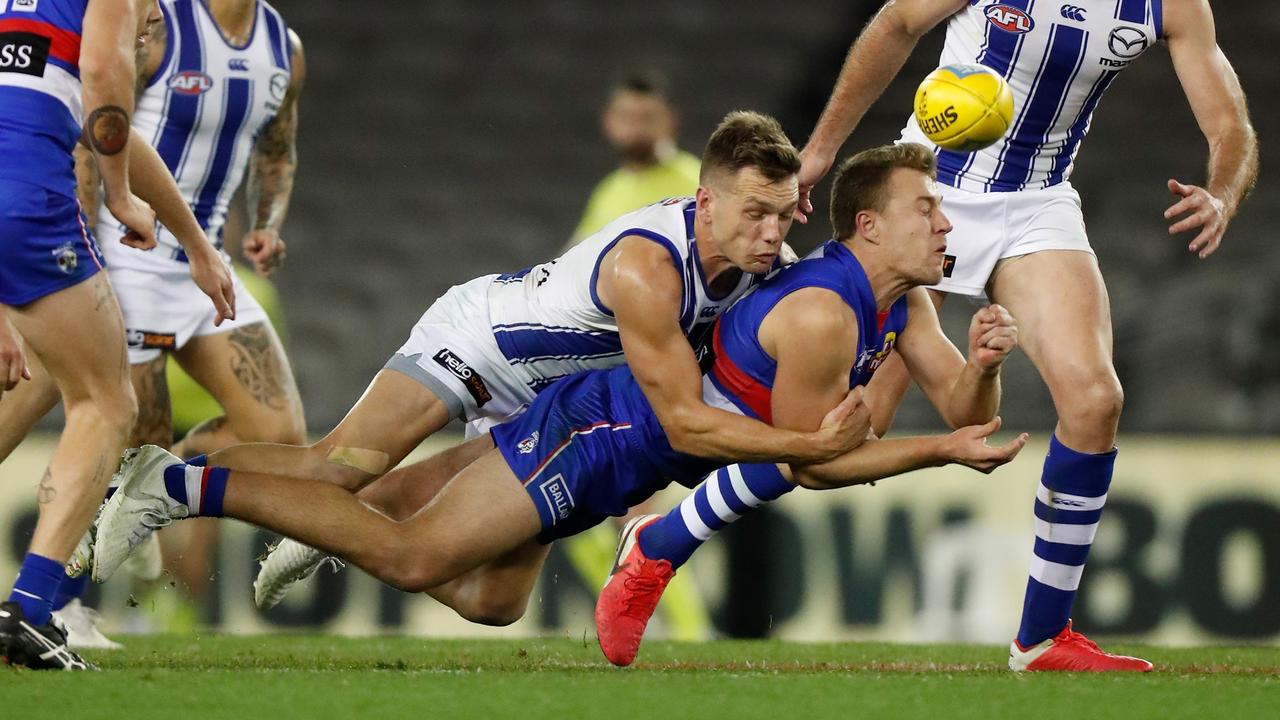 North Melbourne’s Shaun Higgins collars the Bulldogs’ Jack Macrae. Picture: Michael Willson/AFL Photos via Getty Images