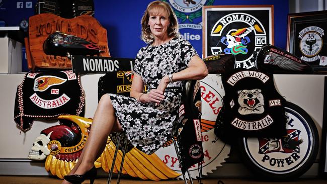 Detective Super Intendent Commander of Gang Squad and Strike Force Raptor Deborah Wallace pictured with some of the outlaw motorcycle gang colours seized by police.