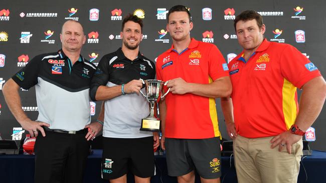 Port Adelaide coach Ken Hinkley and captain Travis Boak with Gold Coast Suns co-captain Steven May and coach Stuart Dew in Shanghai, China. Picture: AAP Image/David Mariuz