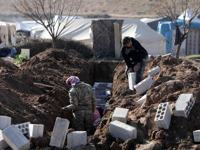 People dig graves to burry victims of a deadly earthquake in the town of Jandaris, in Syria's rebel-held part of Aleppo province. Picture: AFP