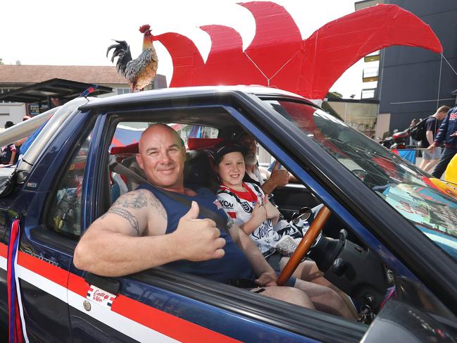 Roosters fans Chris Mulliett and his son Maximus pictured at the Sydney Roosters fan morning at Moore Park after the Roosters win in the 2019 NRL Grand Final.Picture: Richard Dobson