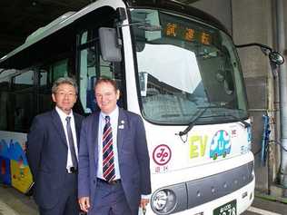 INNOVATIVE PLAN: Mayor Paul Pisasale with Nomura Research Institute senior researcher Daisuke Yajima in front of an electric bus. Picture: Contributed