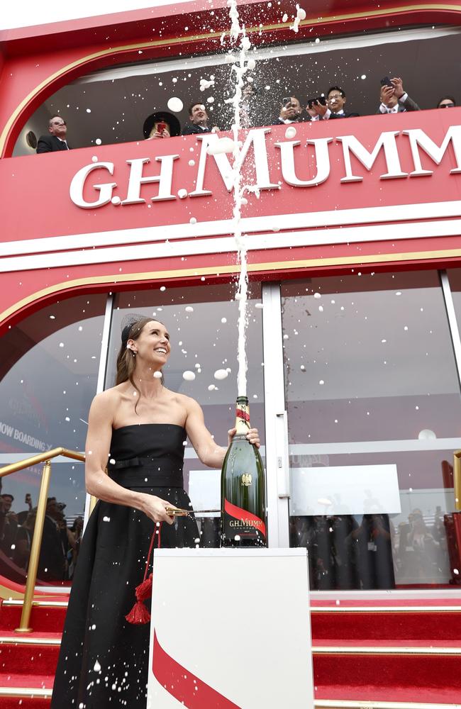 Emma McKeon pops a bottle of Mumm. Picture: Getty Images