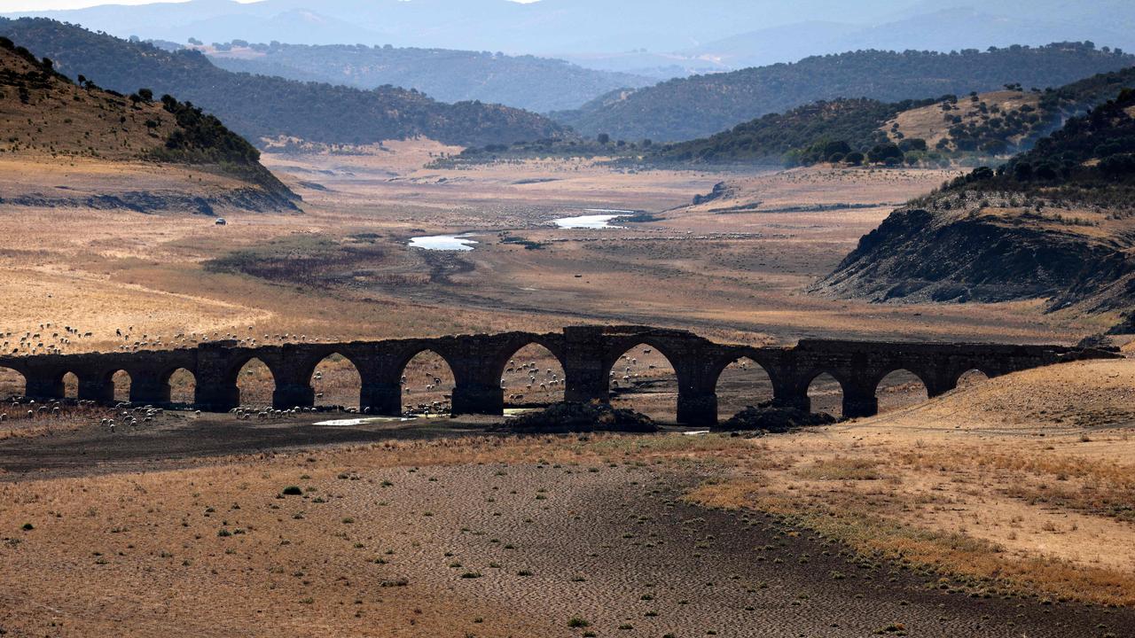 Part of the Guadiana river has dried up and gives way to dry land under the Puente de la Mesta medieval bridge in Villarta de los Montes. Picture: Thomas Coex/AFP
