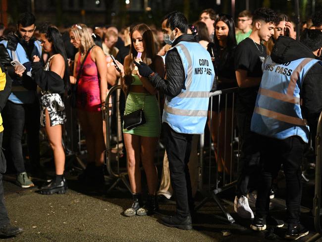 Revellers have their Covid-19 status checked before being allowed to enter Depot Mayfield, a 10,000 capacity club in Manchester, northwest England on New Year's Eve. Picture: AFP